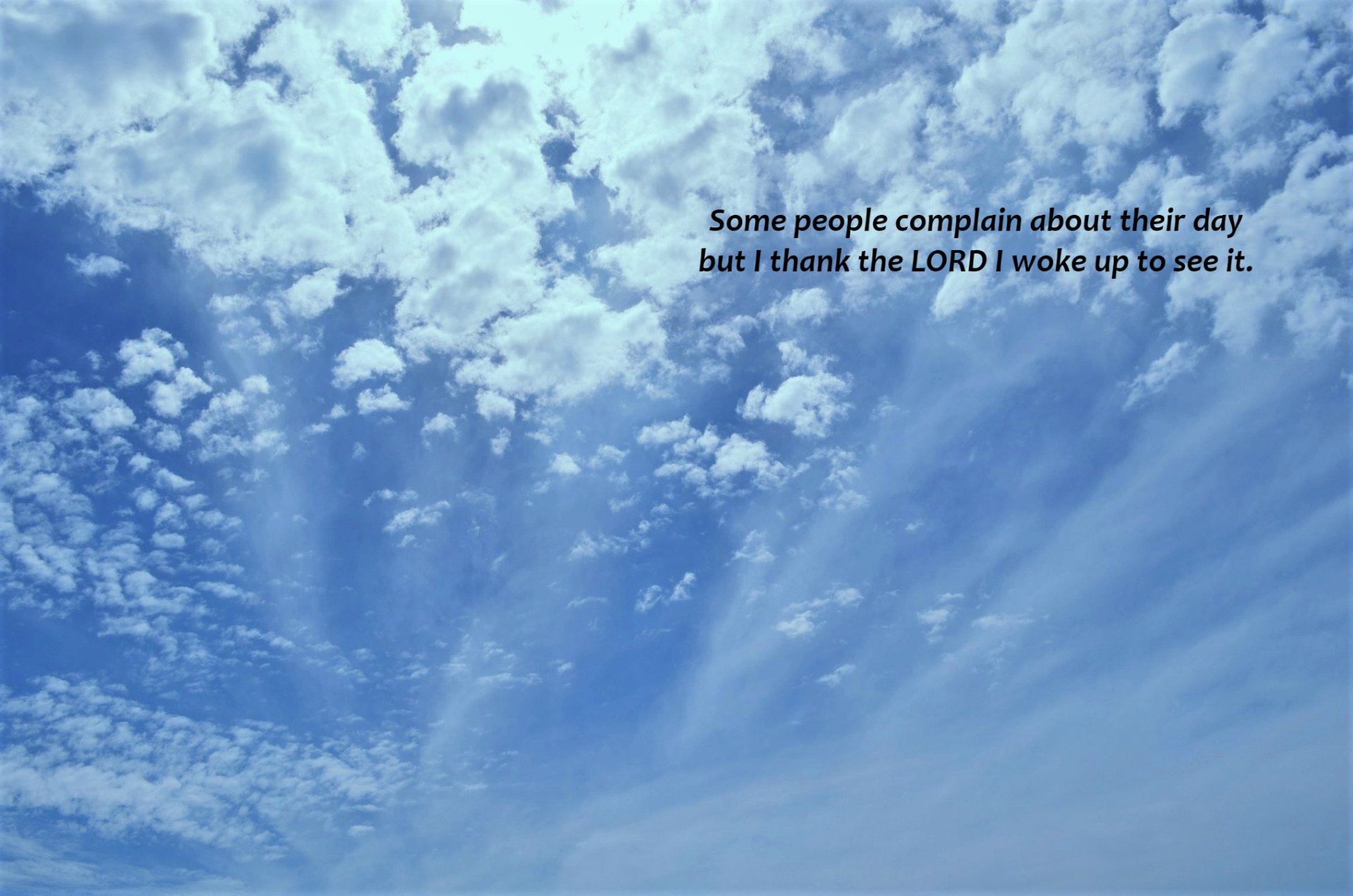 HD desktop wallpaper with a beautiful, bright sky filled with fluffy clouds. Includes the statement, Some people complain about their day but I thank the LORD I woke up to see it, emphasizing a religious and Christian theme.