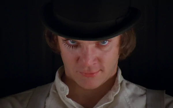 HD PC desktop wallpaper featuring a close-up of the main character from the movie A Clockwork Orange wearing a bowler hat and white collar against a dark background.