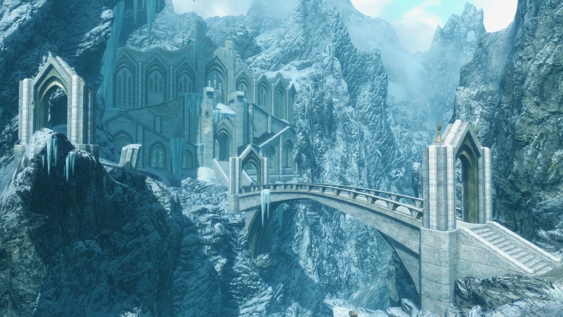 HD PC desktop wallpaper featuring a snowy mountain landscape and ancient stone bridge from the video game The Elder Scrolls V: Skyrim.