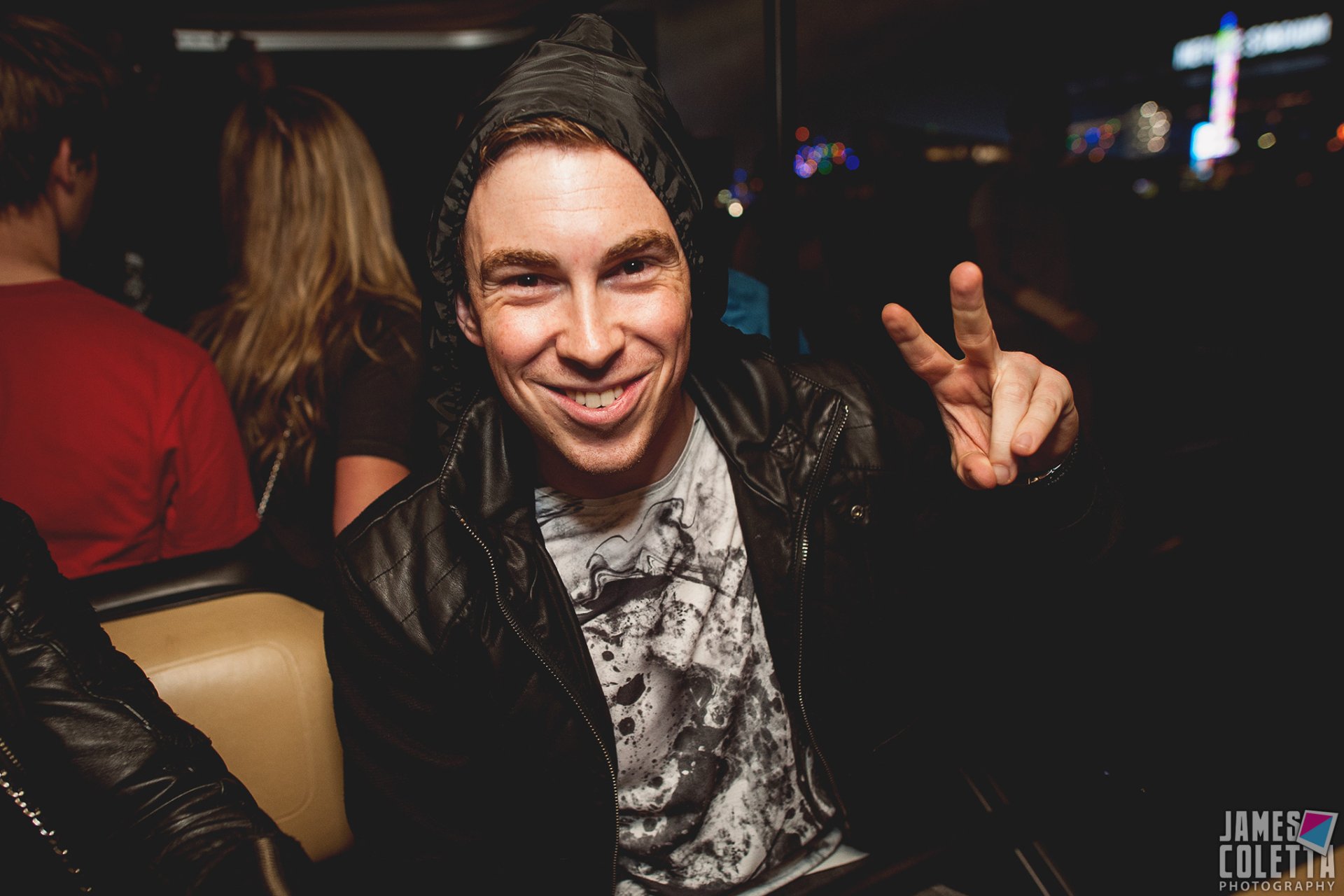 HD PC desktop wallpaper featuring Hardwell smiling and flashing a peace sign at a music event.