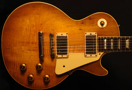 Close-up sunburst electric guitar on black; 2K Quad HD PC desktop wallpaper and background, music/guitar theme.