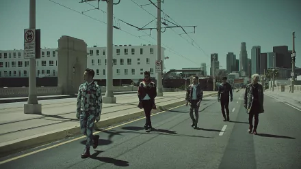Five members of Bigbang walking on an empty city street, with tall buildings and power lines in the background. The image serves as an HD desktop wallpaper and background.