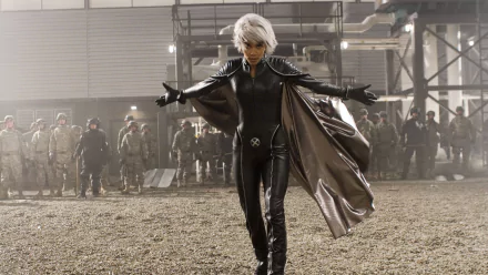 Storm from Marvel Comics stands confidently in a dramatic pose, showcasing her iconic look from *X-Men: The Last Stand*, set against a backdrop of soldiers in a tense scene.