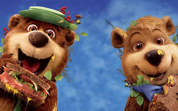 HD PC desktop wallpaper of two cheerful Yogi Bear movie characters smiling against a bright blue sky.