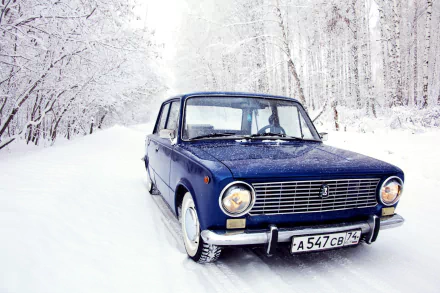 HD desktop wallpaper featuring a classic blue Lada vehicle parked on a snowy road surrounded by snow-covered trees in a winter forest setting.