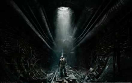 A lone figure in a gas mask stands in a dark, abandoned tunnel illuminated by a shaft of light, inspired by the video game Metro: Last Light. HD desktop wallpaper and background.