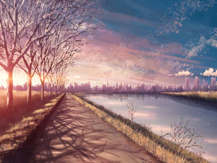 HD anime landscape wallpaper showing a serene sunset over a city skyline. The sky is beautifully colored, with trees lining a path beside a calm river reflecting the vibrant sunset hues.