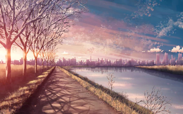 HD anime landscape wallpaper showing a serene sunset over a city skyline. The sky is beautifully colored, with trees lining a path beside a calm river reflecting the vibrant sunset hues.