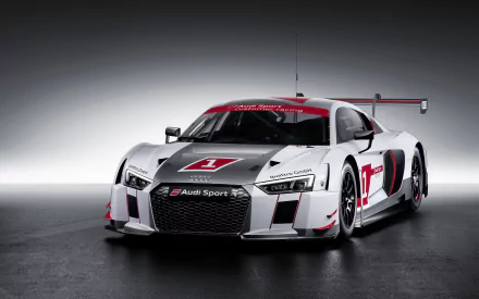 White and red Audi R8 LMS race car front three-quarter view on a dark studio backdrop — 2K Quad HD PC desktop wallpaper/background.