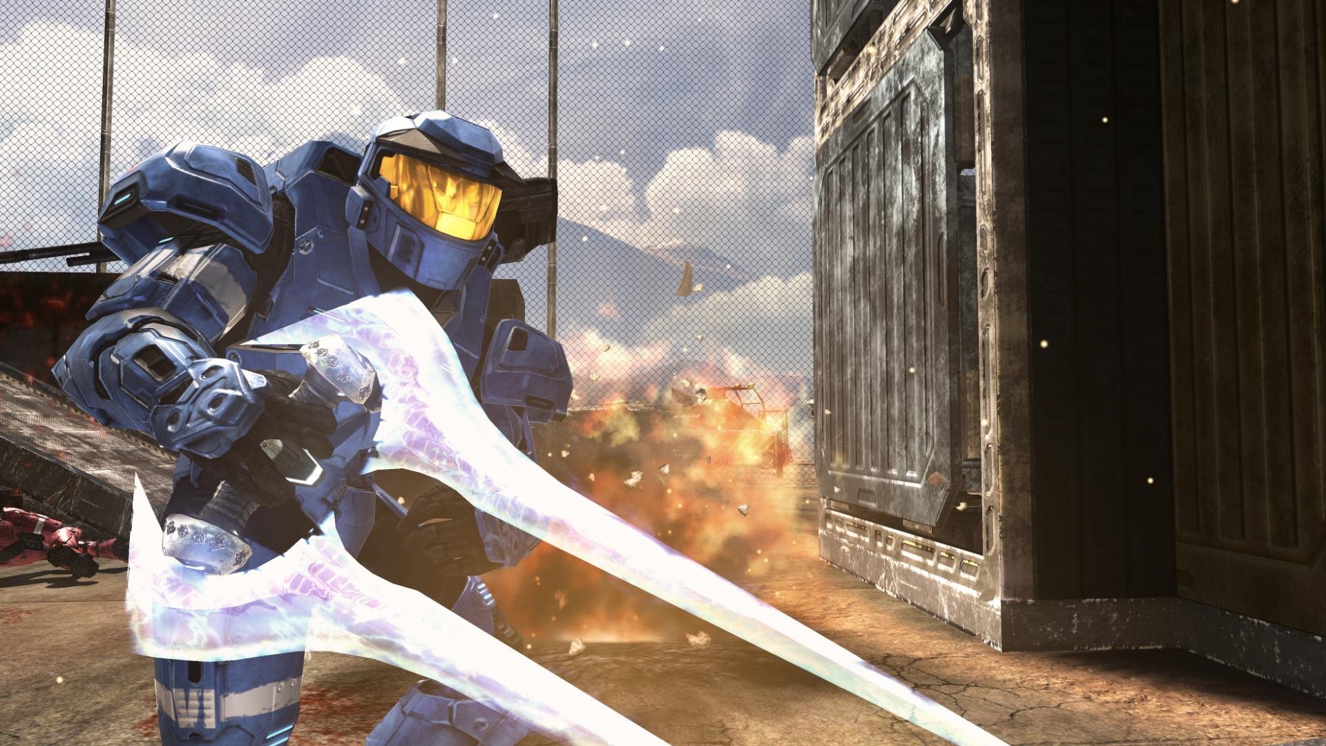 HD PC desktop wallpaper featuring a blue-armored Spartan warrior from the video game Halo, wielding energy swords in a battle scene with explosions.