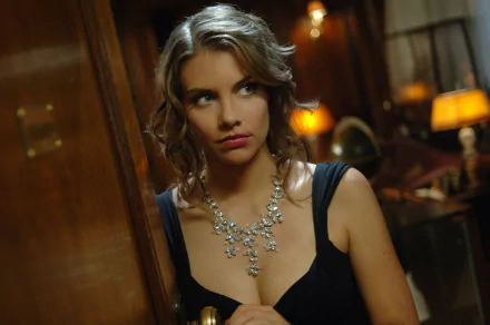 A captivating HD wallpaper featuring Lauren Cohan from The Vampire Diaries, portraying an intense moment in a dimly lit room, accentuated by her elegant necklace and expressive gaze.