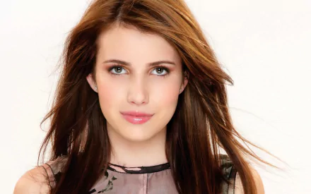 Emma Roberts poses for a high-definition desktop wallpaper, showcasing her striking features and flowing hair against a clean background.