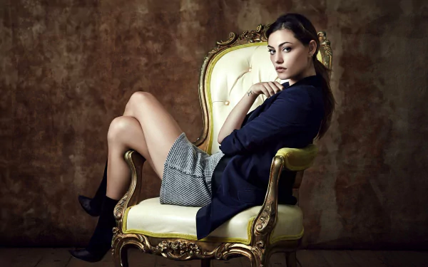 HD PC desktop wallpaper featuring celebrity Phoebe Tonkin seated on an ornate gold and white chair against a textured brown backdrop.