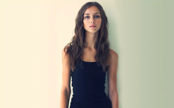 Portrait of Rachel Cook, an American actress with long brunette hair and striking blue eyes, against a plain light background.