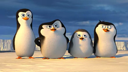A vibrant HD desktop wallpaper featuring the mischievous penguins from Penguins of Madagascar, showcasing their playful expressions against a snowy backdrop.