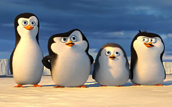A vibrant HD desktop wallpaper featuring the mischievous penguins from Penguins of Madagascar, showcasing their playful expressions against a snowy backdrop.