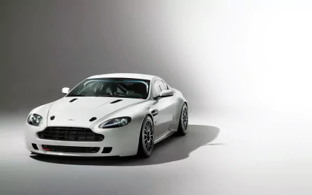 A high-definition PC desktop wallpaper featuring a sleek white Aston Martin Vantage GT4 vehicle against a minimalist gray and white background.