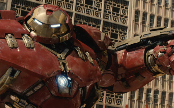 Hulkbuster from Avengers: Age of Ultron stands poised in a striking HD wallpaper, showcasing the impressive detail and power of this iconic armor against a city backdrop.