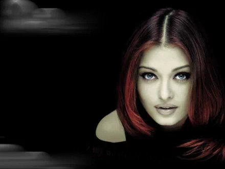 HD desktop wallpaper featuring a striking image of celebrity Aishwarya Rai with captivating eyes, against a dark background.