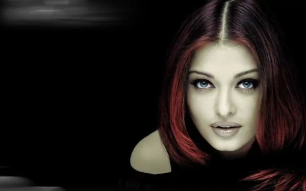 HD desktop wallpaper featuring a striking image of celebrity Aishwarya Rai with captivating eyes, against a dark background.