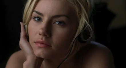 A close-up of Elisha Cuthbert from the movie The Girl Next Door, featuring her contemplative expression while wearing a headset, serving as an HD desktop wallpaper.