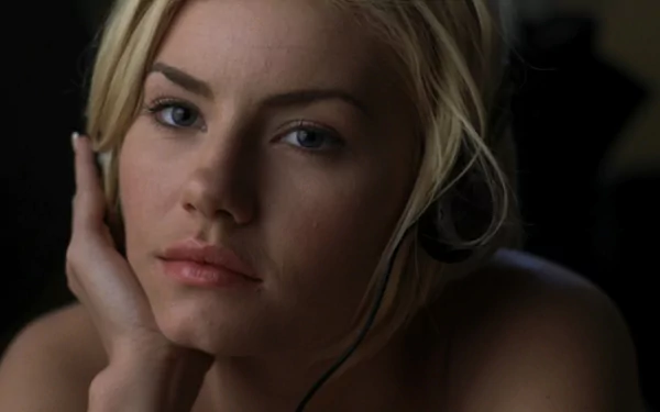 A close-up of Elisha Cuthbert from the movie The Girl Next Door, featuring her contemplative expression while wearing a headset, serving as an HD desktop wallpaper.