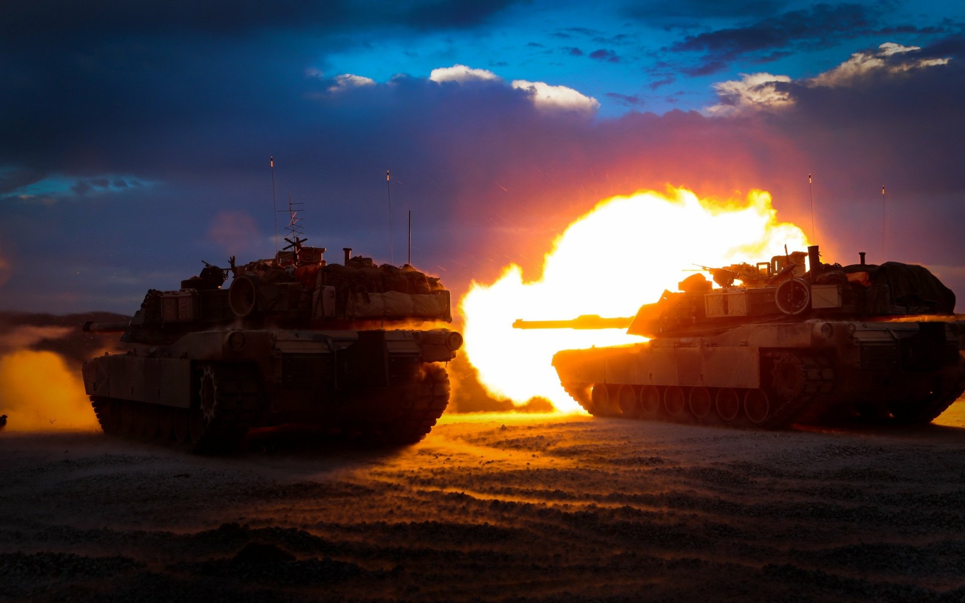HD desktop wallpaper featuring two military M1 Abrams tanks firing simultaneously against a dusk sky, capturing dynamic action and intense combat atmosphere.