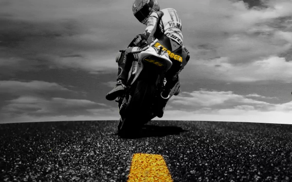 Valentino Rossi leans into a sharp turn on his motorcycle, set against a dramatic black-and-white background with a vibrant yellow line, creating a striking HD desktop wallpaper for sports fans.