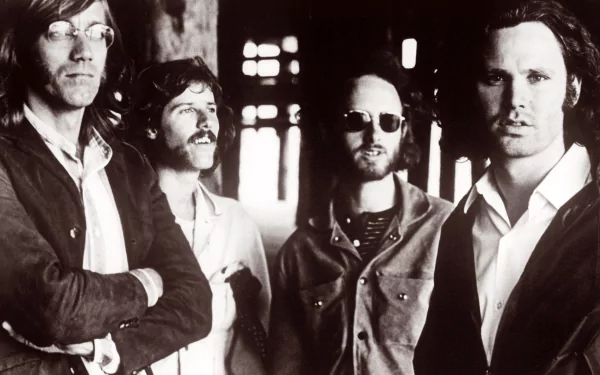 Black and white HD desktop wallpaper featuring the rock band The Doors, with all four members standing together in a moody, shadowed setting.