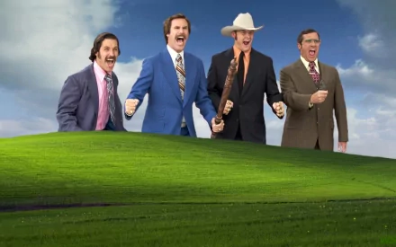 HD PC desktop wallpaper featuring characters from the movie Anchorman: The Legend of Ron Burgundy standing with energetic expressions against a clear sky and green hill background.