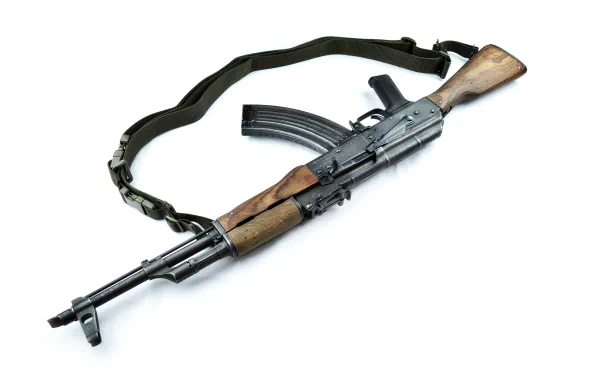 A detailed HD desktop wallpaper featuring an AK-47 with a wooden stock and sling, showcasing the distinctive design and craftsmanship of this man-made firearm.