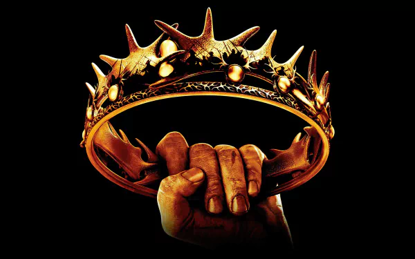 A dramatic image of a hand gripping a spiked crown against a dark background, inspired by the iconic themes of the TV show Game of Thrones, serves as an HD wallpaper for desktops.
