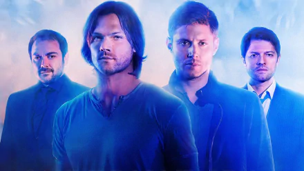 A vibrant HD wallpaper featuring the main characters from Supernatural: Sam Winchester, Dean Winchester, Castiel, and Crowley, set against a mystical blue backdrop.