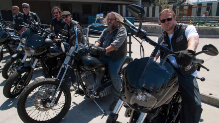 A scene from the TV show Sons of Anarchy, featuring a group of rough-looking bikers on black motorcycles, showcasing the show's intense atmosphere and camaraderie. High-definition wallpaper.