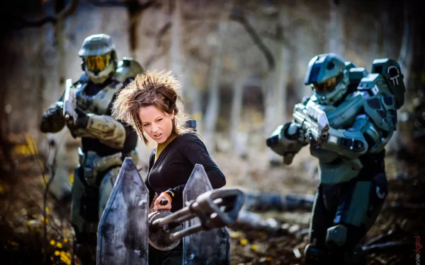 HD PC desktop wallpaper featuring Lindsey Stirling with a violin amidst two futuristic armored figures in a wooded setting, blending music and sci-fi elements.