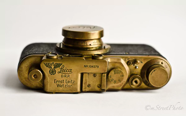 Close-up of a vintage Leica camera base plate on a neutral background — 4K Ultra HD PC desktop wallpaper featuring a man-made camera.