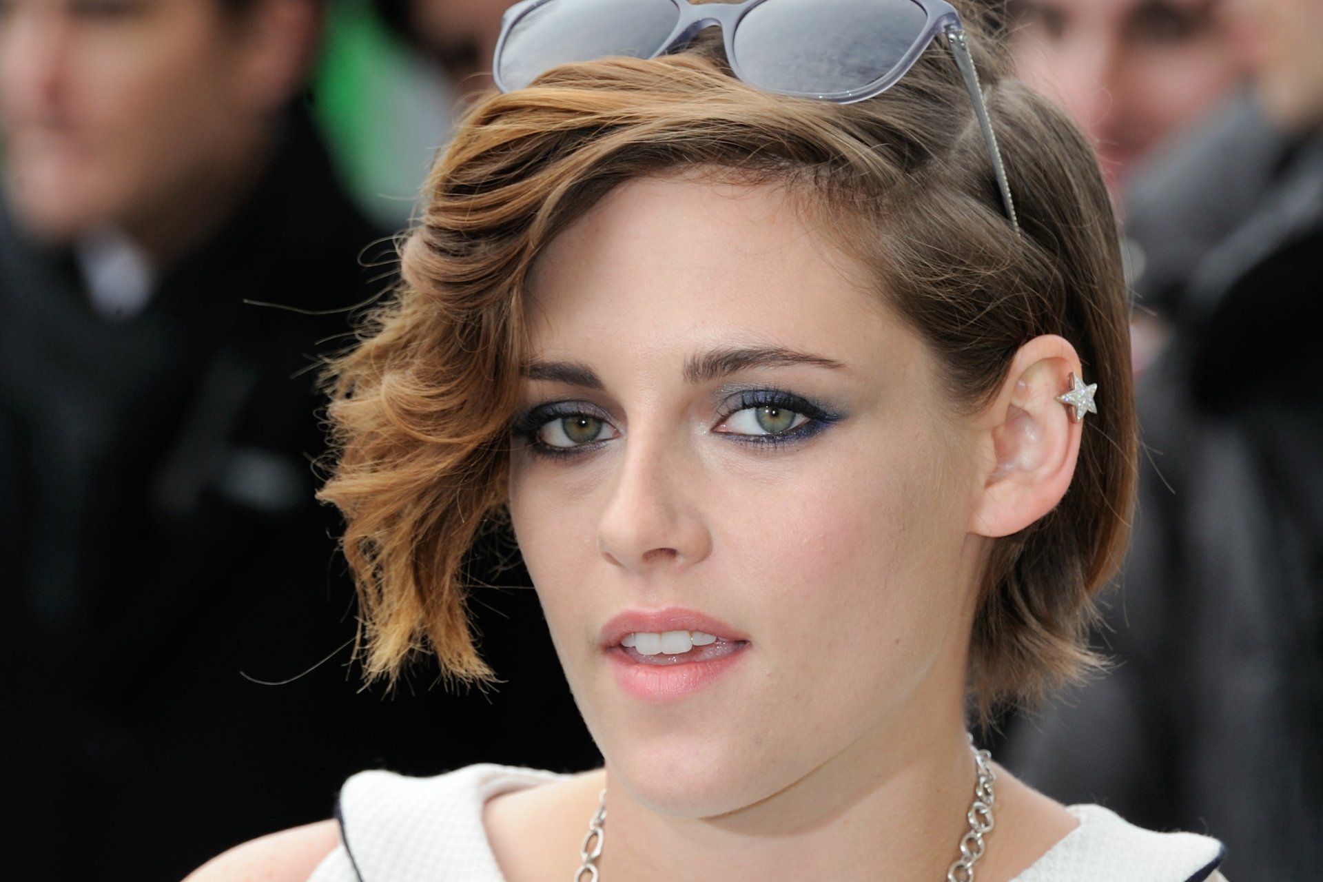 Close-up of Kristen Stewart with styled hair and sunglasses, showcasing her unique look. This image serves as a vibrant HD desktop wallpaper.