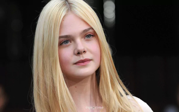 HD PC desktop wallpaper featuring a close-up portrait of celebrity Elle Fanning with her blonde hair and serene expression against a dark blurred background.