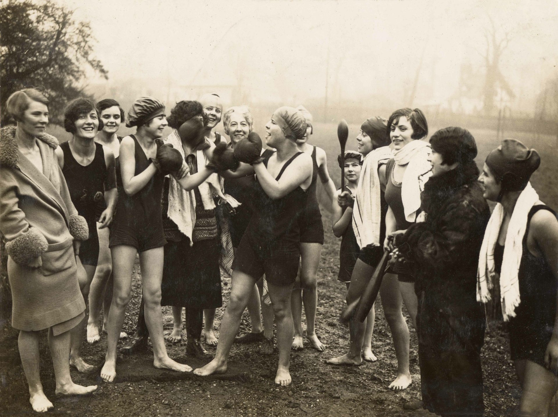 Vintage black-and-white photo of women in swimwear playfully sparring with boxing gloves outdoors; a sports-themed 4K Ultra HD PC desktop wallpaper and background.