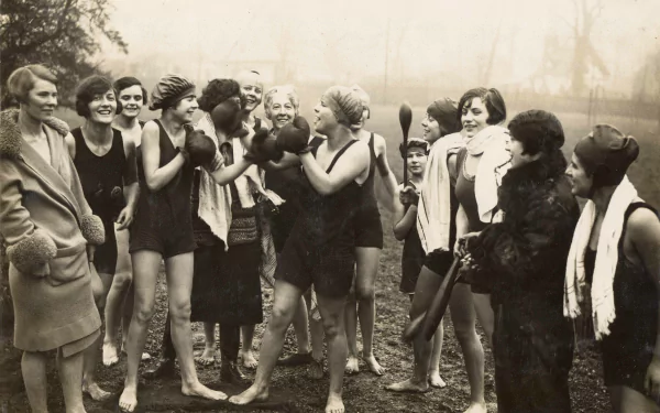 Vintage black-and-white photo of women in swimwear playfully sparring with boxing gloves outdoors; a sports-themed 4K Ultra HD PC desktop wallpaper and background.
