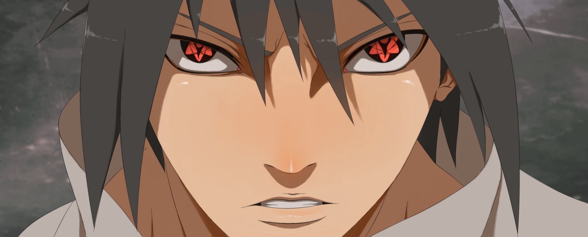 Close-up of Sasuke Uchiha from the anime Naruto, featuring his intense expression and iconic red Sharingan eyes. High-definition wallpaper for desktop backgrounds.