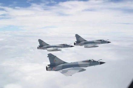 A striking HD desktop wallpaper featuring three Dassault Mirage 2000 fighter jets soaring through a clear sky, showcasing their sleek design and military prowess.