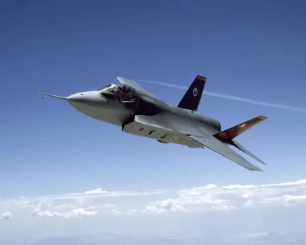 A Lockheed Martin F-35 Lightning II soaring through a clear blue sky, showcasing advanced military technology in a striking HD desktop wallpaper.