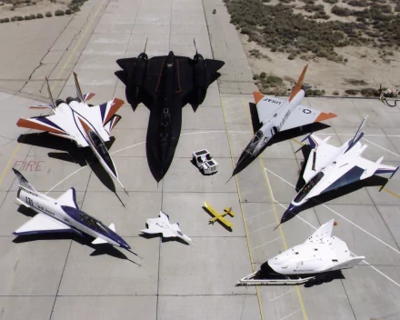 A striking collection of iconic aircraft, featuring the General Dynamics F-16 Fighting Falcon, Lockheed SR-71 Blackbird, and McDonnell Douglas F-15 Eagle, set against a desert backdrop.