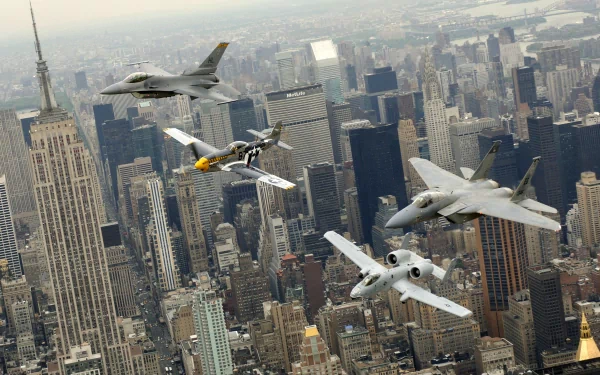 A stunning HD desktop wallpaper showcasing a formation of military jet fighters, including the McDonnell Douglas F-15 Eagle, General Dynamics F-16 Fighting Falcon, and Fairchild Republic A-10 Thunderbolt II, over a cityscape.