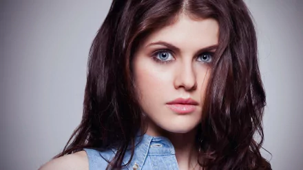HD desktop wallpaper featuring celebrity Alexandra Daddario, showcasing her striking blue eyes and long dark hair in a close-up portrait.