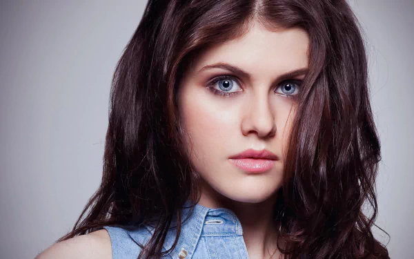 HD desktop wallpaper featuring celebrity Alexandra Daddario, showcasing her striking blue eyes and long dark hair in a close-up portrait.