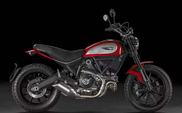 HD desktop wallpaper of a Ducati Scrambler motorcycle in red and black, showcased against a dark background.