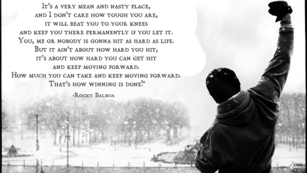 A high-definition wallpaper featuring a motivational quote from Rocky Balboa with a black-and-white image of Rocky raising his fist triumphantly.