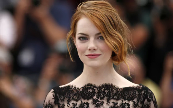 HD PC desktop wallpaper featuring a close-up of celebrity Emma Stone in an elegant black lace outfit with soft waves in her red hair.